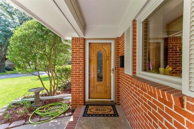 Handsome wood door with glass inlays grace the ent