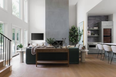Living room featuring stairs, a towering ceiling,