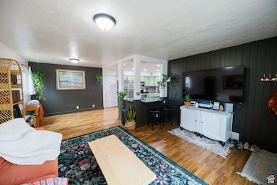 Living room featuring a textured ceiling and wood finished floors