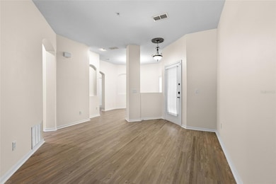 High Ceiling Entrance Looks into Living Room