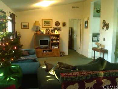 Living room , kitchen to the right and door leads 