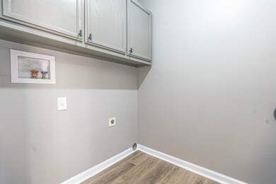 Laundry area featuring dark wood-type flooring, wa