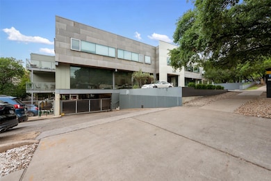 View of property featuring uncovered parking