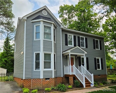 View of front facade with fence and crawl space
