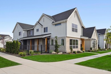 Modern farmhouse featuring board and batten siding, a front lawn, and a shingled roof