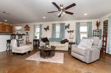Low-maintenance concrete flooring flows throughout the home eliminating carpet.