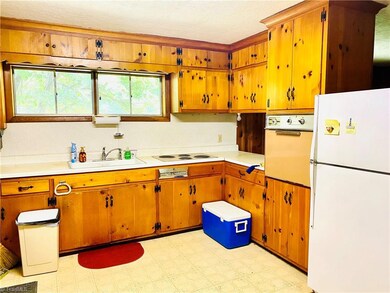 Charming knotty pine cabinetry in cozy kitchen