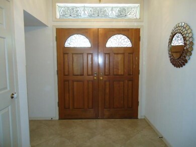 The entrance is spacious and includes three leaded