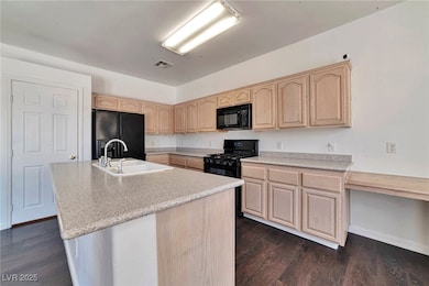 Kitchen with black appliances, light brown cabinet