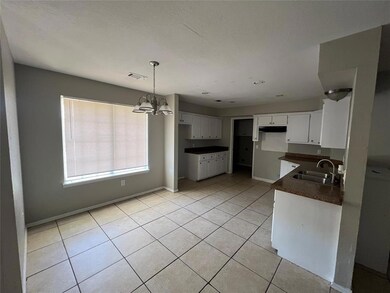 Kitchen featuring light tile patterned floors, an 
