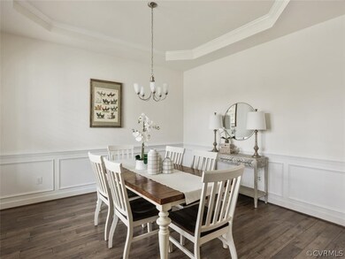 Formal dining room has tray ceiling with molding,