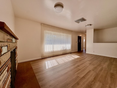 Unfurnished living room with a fireplace and wood finished floors