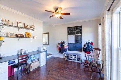 Office with crown molding, wood finished floors, b