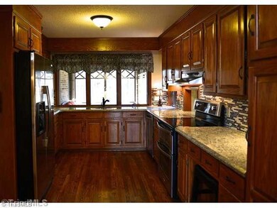 Kitchen. SS appliances, Hardwoods, Granite, Glass top range w/ Dual Oven, Tile Blacksplash, Pantry, Garbage Disposal, Pull out drawers, desk w/organizer, LED under cabinet lighting, Faucet w/Pull out Sprayer