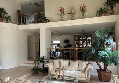 Living area featuring a chandelier and a towering