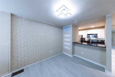 Kitchen featuring white cabinetry, visible vents, 
