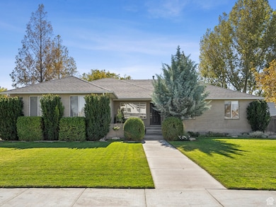 View of front of house with a front lawn and roof with shingles