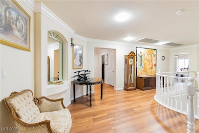 Sitting room featuring ornamental molding and ligh