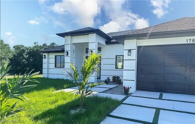 View of front of home featuring concrete driveway,