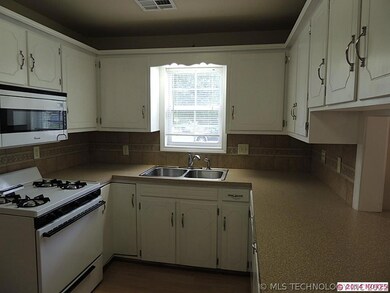 Kitchen is totally updated with new cabinets, tile