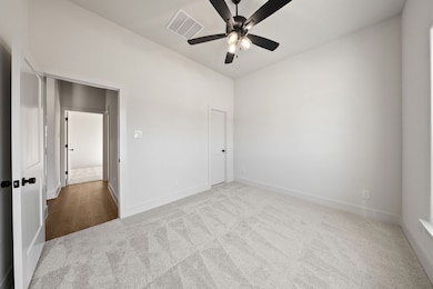 Unfurnished room with carpet floors and a ceiling fan