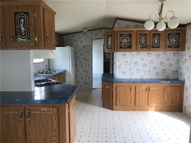 Another view of kitchen with room for a table on r