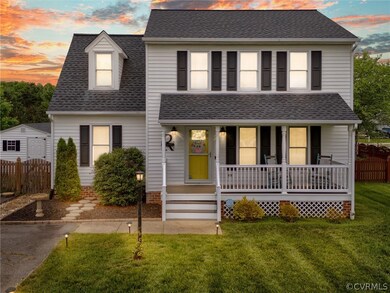 View of front of house featuring a porch and a law