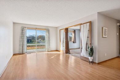 The living room allows you to escape out the sliding glass doors to your private patio overlooking the pond and the western sunlight. Notice the elegant French doors for privacy that lead to the 2nd BR / office space.