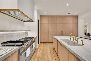 Kitchen featuring a sink, range with two ovens, r