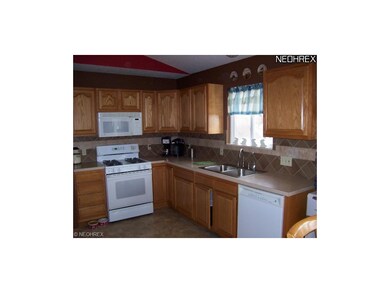 This kitchen offers loads of cupboard space. Notic