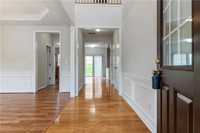 Entryway with a decorative wall, light wood-type flooring.