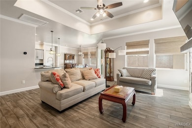 Living area with visible vents, wood finished floo