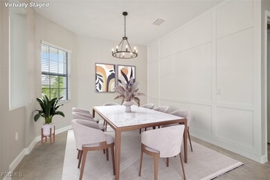 Dining space featuring a decorative wall, a chandelier, and light tile patterned floors