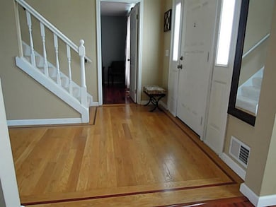 Foyer The spacious foyer features in-laid hardwood