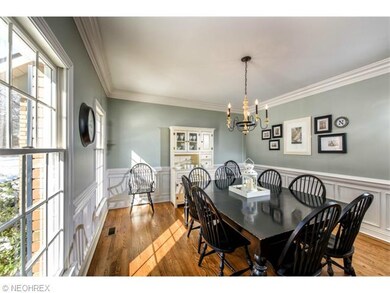 Formal dining room with hardwood floor and crown m