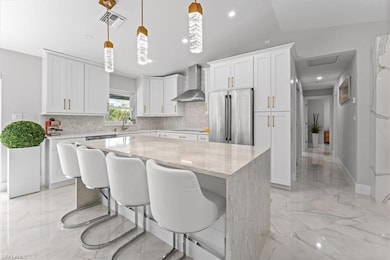 Kitchen featuring high end refrigerator, wall chim