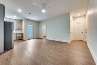 Unfurnished living room with ceiling fan, light wood-style floors, and recessed lighting