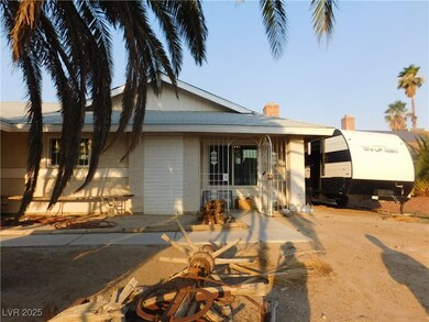 View of front of house with a chimney and brick si