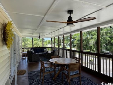 Sunroom / solarium with a ceiling fan, an outdoor living space, and coffered ceiling