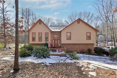Split foyer home with brick siding and a chimney