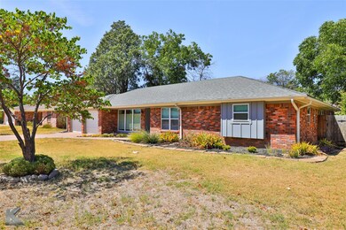 Ranch-style house featuring a garage and a front l