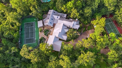 This private oasis surrounded by trees is set back