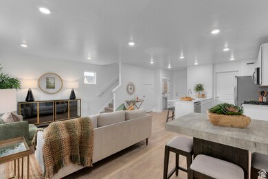 Living area featuring light wood-style floors, stairway, and recessed lighting