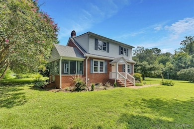 View of front of home featuring a chimney, a front