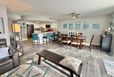 Living room with wood tiled floors, baseboards, an