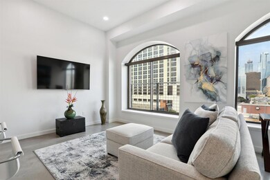 Living room with recessed lighting, a city view, 