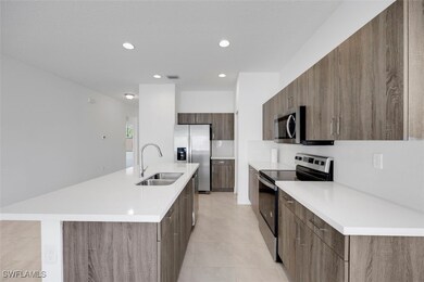 Kitchen with stainless steel appliances, light cou
