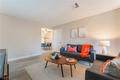 Living room featuring baseboards, light wood-style