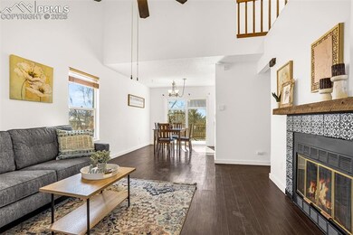 Living room with a high ceiling, baseboards, hardw
