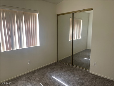 Unfurnished bedroom with carpet, a closet, and bas